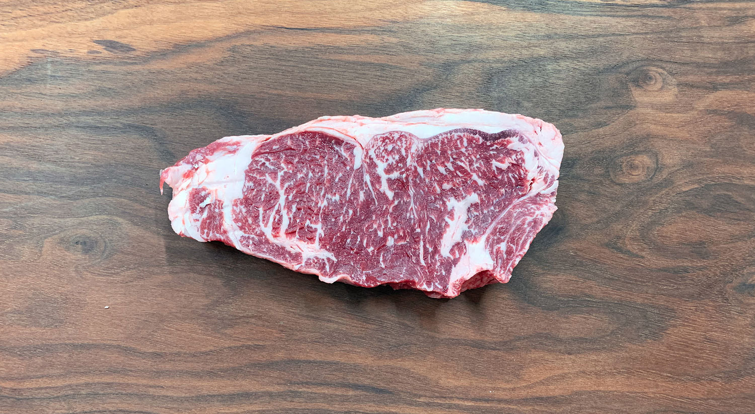Bone-In New York Strip Crimson Crest 3+ Wagyu F1 Crossbred